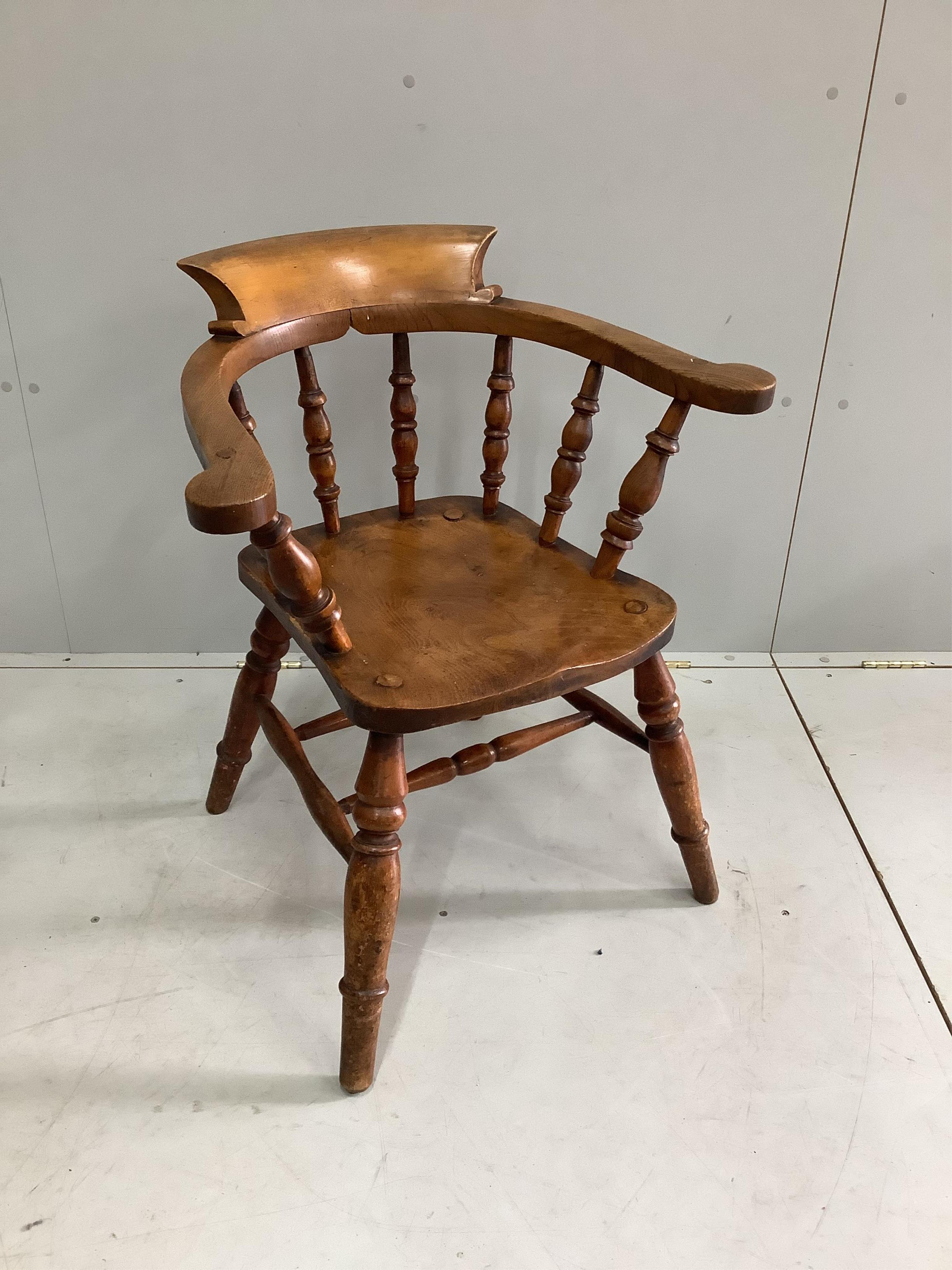 A Victorian elm and beech smoker's bow chair, width 65cm, depth 46cm, height 77cm. Condition - fair